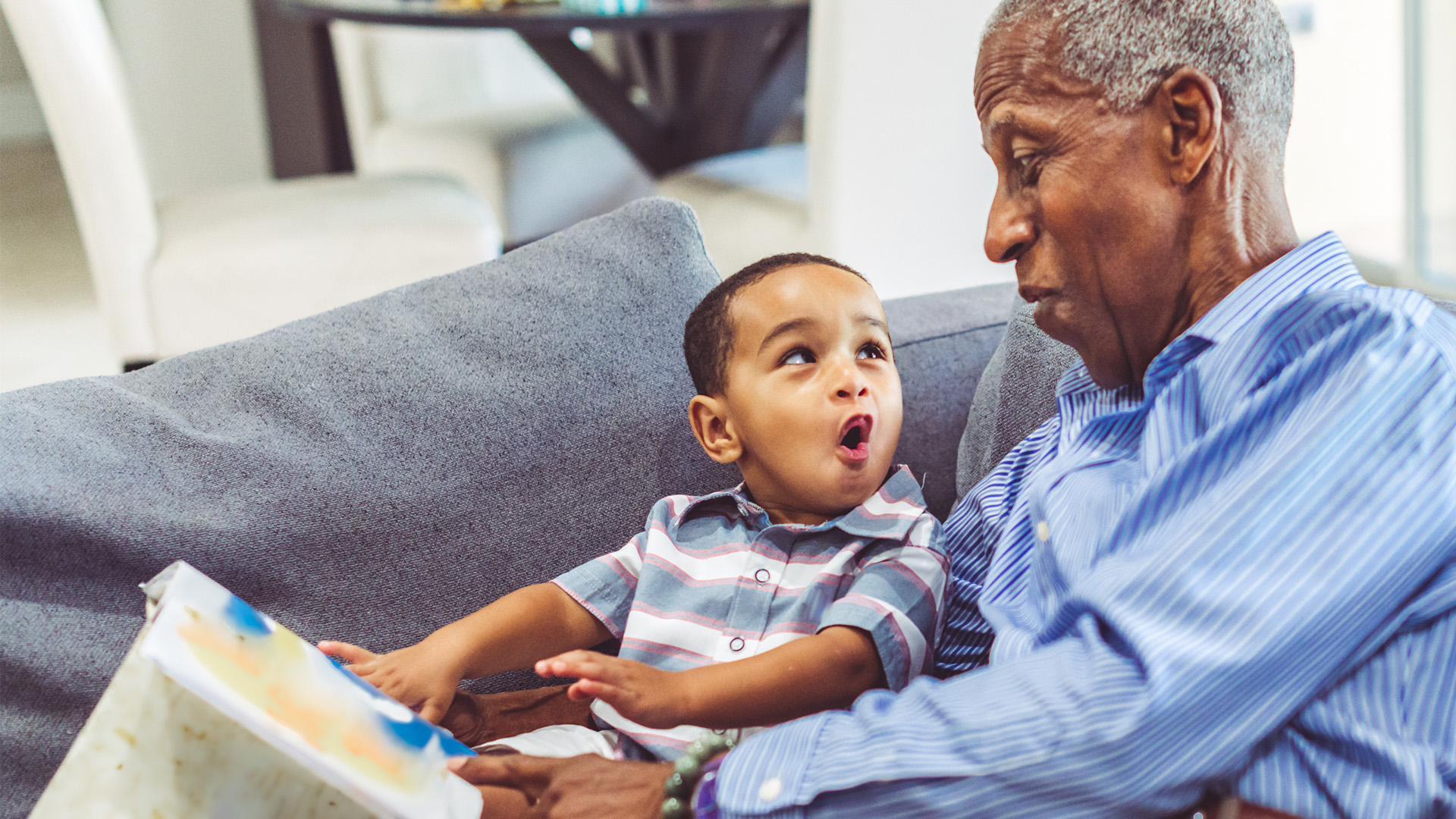 Grandfather and grandson reading a book